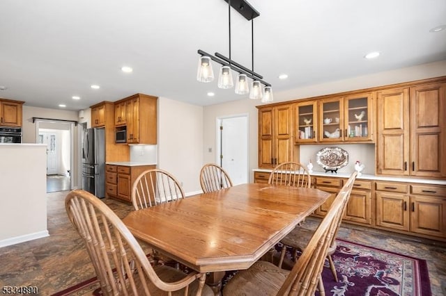 dining area featuring baseboards and recessed lighting