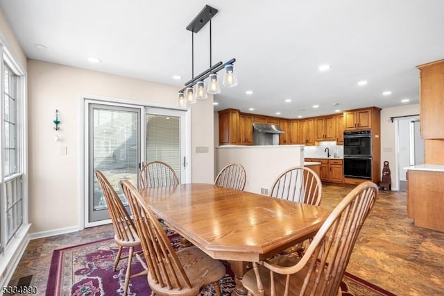 dining area with recessed lighting and baseboards