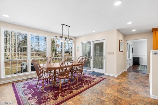 dining room with baseboards and recessed lighting