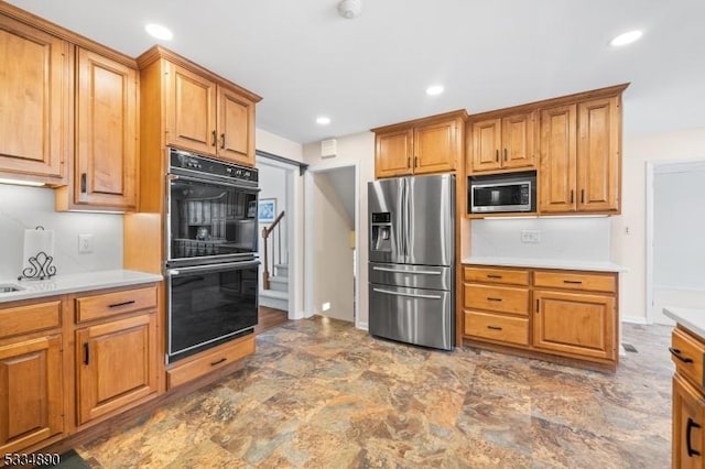 kitchen featuring appliances with stainless steel finishes, light countertops, and recessed lighting