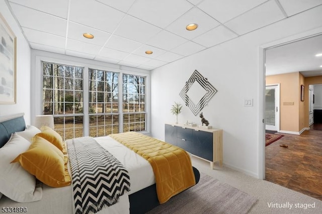 carpeted bedroom featuring recessed lighting, a drop ceiling, and baseboards