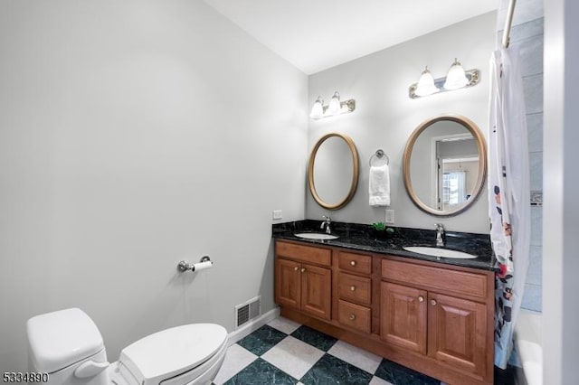 full bath with visible vents, a sink, toilet, and tile patterned floors