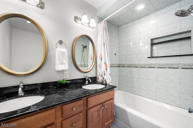 bathroom featuring a sink, shower / bathtub combination with curtain, and double vanity