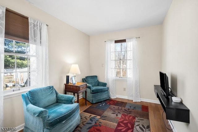 living area featuring wood finished floors and baseboards