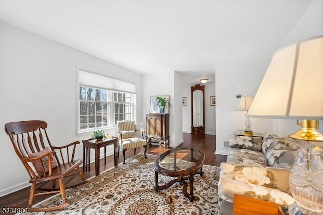 living area with dark wood-style flooring and baseboards