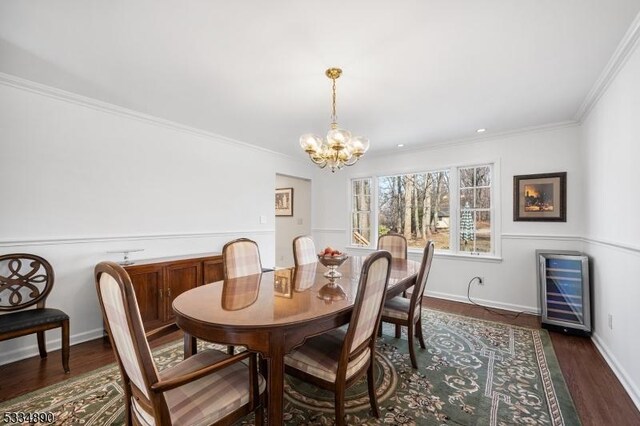 dining space with wine cooler, baseboards, ornamental molding, dark wood finished floors, and an inviting chandelier