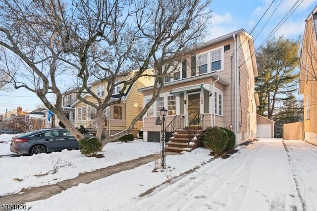 view of front of home with a garage and an outdoor structure