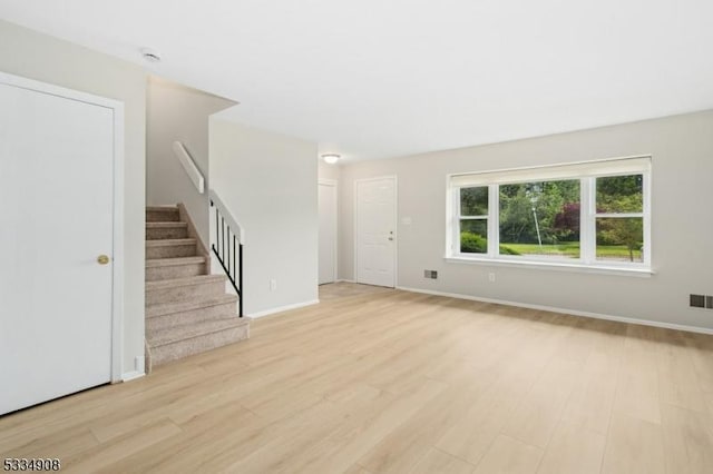 18 Yarmouth Ct, Scotch Plains Twp, NJ 07076 - unfurnished living room with light wood finished floors, stairs, and baseboards
