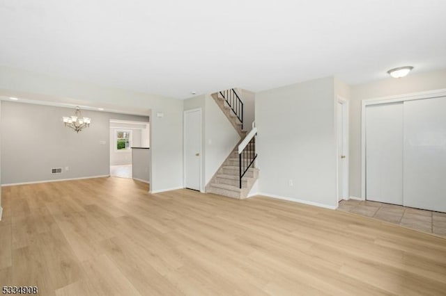 18 Yarmouth Ct, Scotch Plains Twp, NJ 07076 - unfurnished living room featuring a chandelier, light wood finished floors, stairs, and baseboards