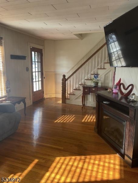 entrance foyer with stairs and wood finished floors