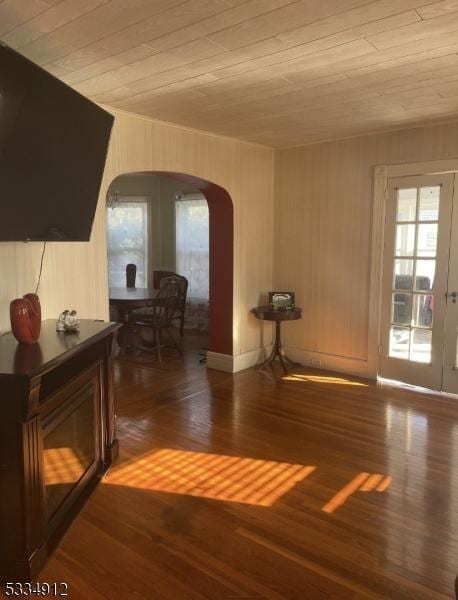 interior space with arched walkways, french doors, wood finished floors, and wood ceiling