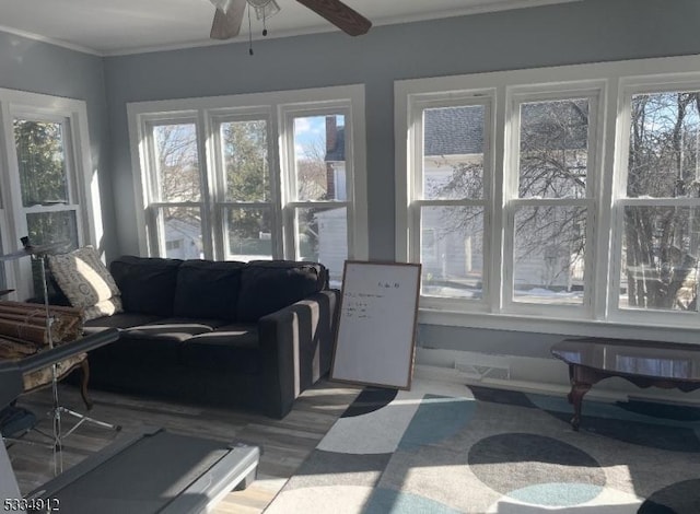 sunroom / solarium with a ceiling fan, a healthy amount of sunlight, and visible vents