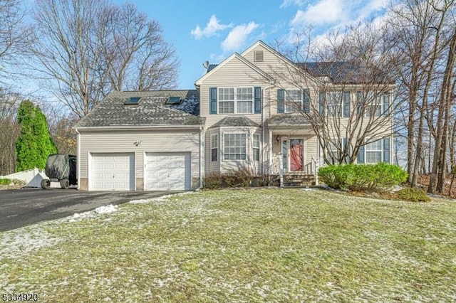 front of property with a garage and a front lawn