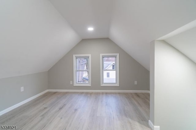 bonus room with vaulted ceiling and light hardwood / wood-style floors