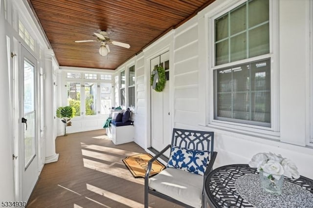 sunroom / solarium with wood ceiling and ceiling fan