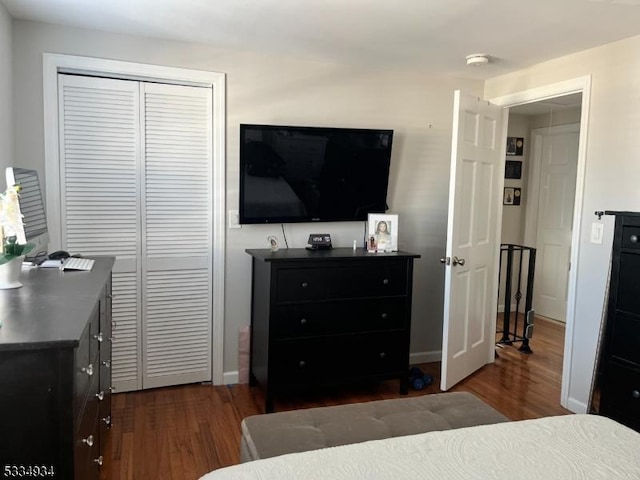 bedroom featuring a closet and dark hardwood / wood-style floors