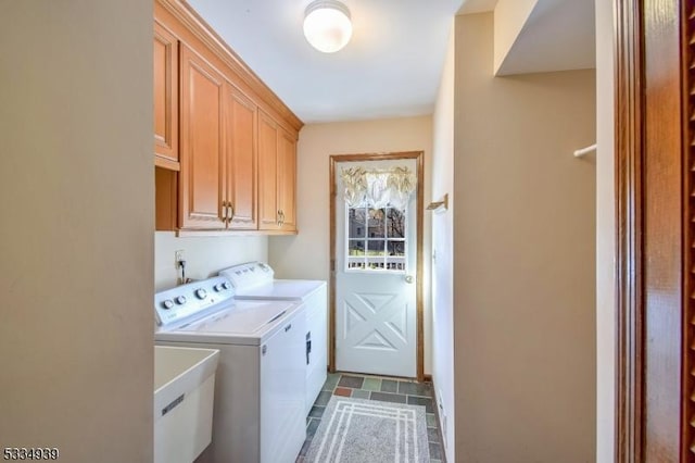 clothes washing area with cabinets, sink, and washing machine and dryer