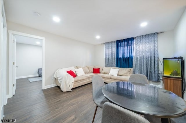 living room with dark hardwood / wood-style flooring