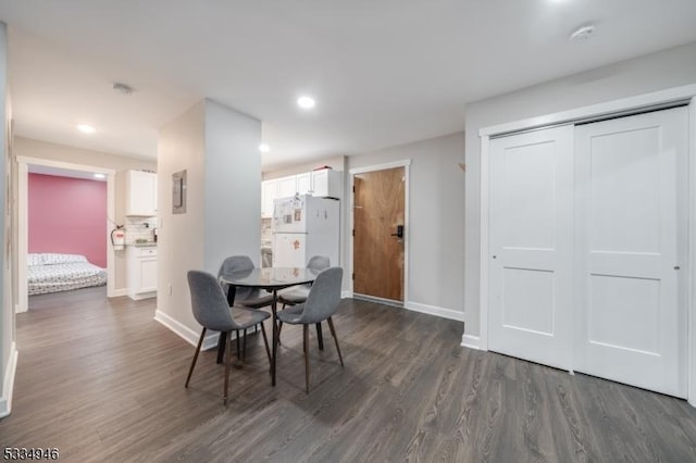 dining space with dark hardwood / wood-style floors