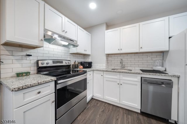 kitchen featuring sink, white cabinetry, appliances with stainless steel finishes, dark hardwood / wood-style floors, and light stone countertops