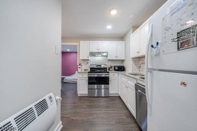 kitchen with white cabinetry, appliances with stainless steel finishes, sink, and decorative backsplash