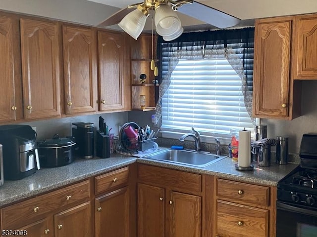 kitchen featuring ceiling fan, sink, and black gas range oven