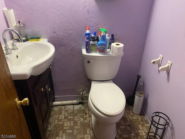 bathroom featuring vanity and toilet