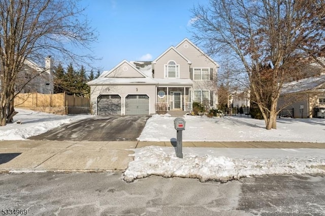 view of property with a garage and a porch