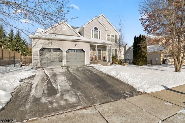 view of front property with a porch and a garage