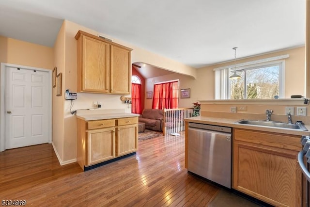 kitchen featuring pendant lighting, sink, light brown cabinetry, dishwasher, and dark hardwood / wood-style flooring