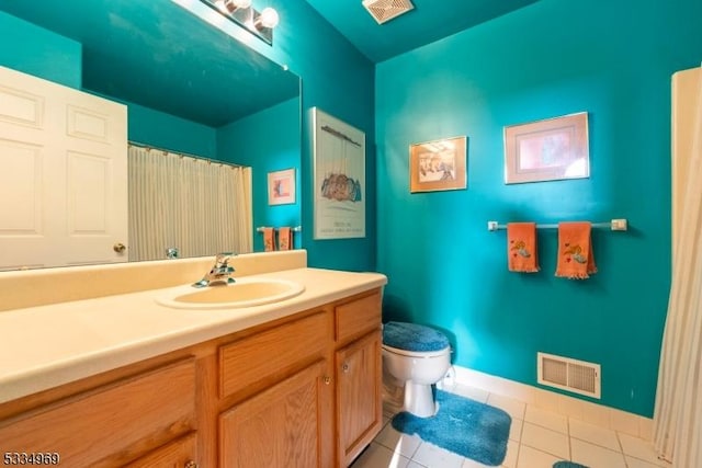 bathroom with vanity, toilet, and tile patterned flooring