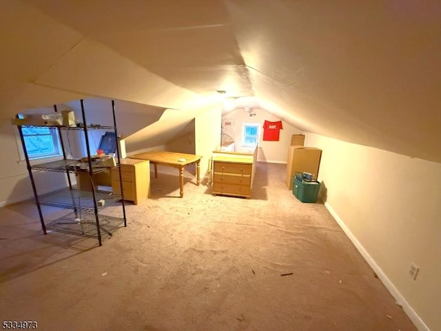 bonus room featuring lofted ceiling and carpet floors