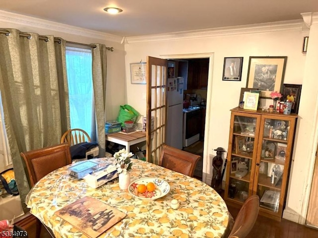 dining area featuring crown molding and wood-type flooring