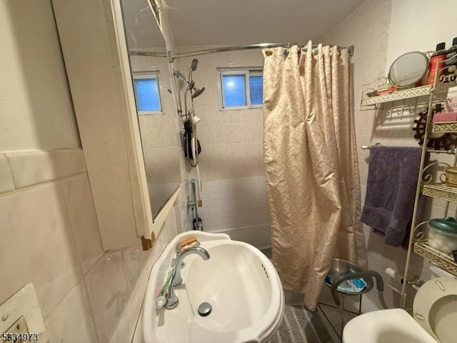 full bathroom with sink, toilet, and shower / bath combo with shower curtain