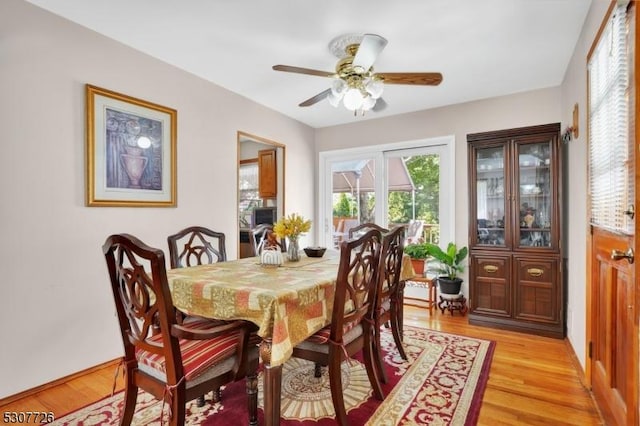 dining area with light hardwood / wood-style floors and ceiling fan