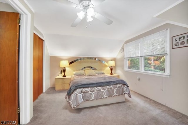 carpeted bedroom with vaulted ceiling and ceiling fan