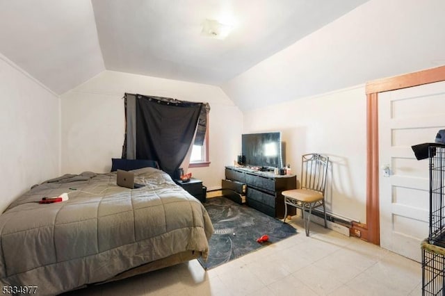 bedroom with lofted ceiling and a baseboard heating unit