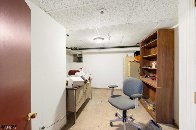 home office with a paneled ceiling