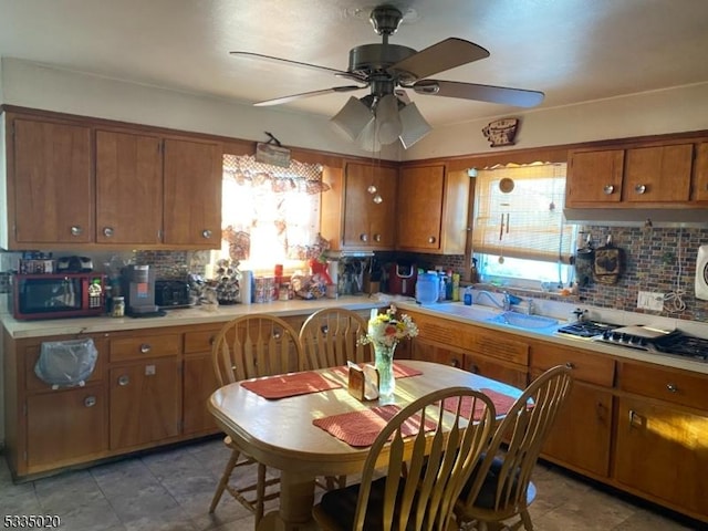 kitchen featuring sink, ceiling fan, and decorative backsplash