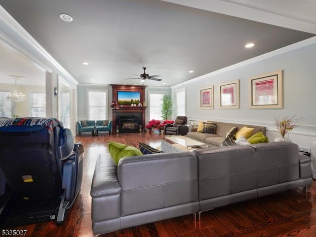 living room featuring crown molding, hardwood / wood-style floors, and ceiling fan