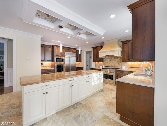 kitchen featuring a kitchen island, sink, white cabinets, custom exhaust hood, and built in appliances