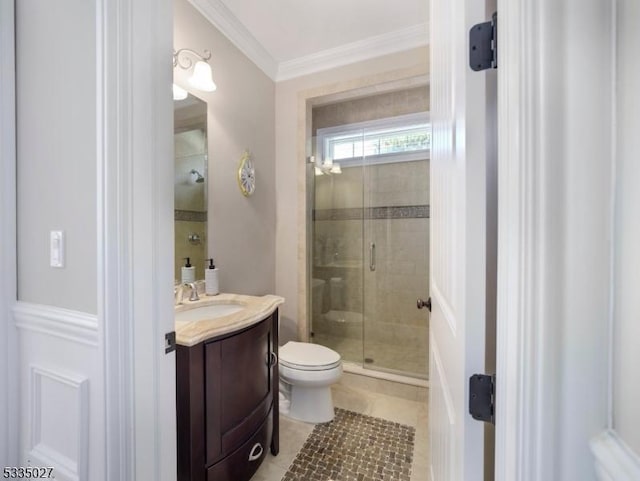 bathroom featuring crown molding, vanity, a shower with shower door, tile patterned floors, and toilet