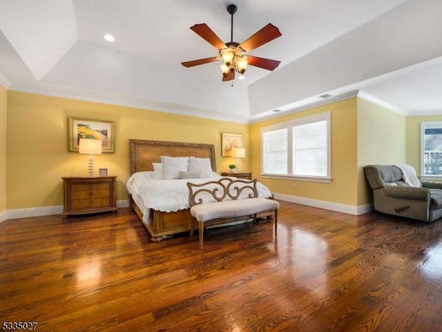 bedroom featuring ornamental molding, dark hardwood / wood-style floors, ceiling fan, and a tray ceiling