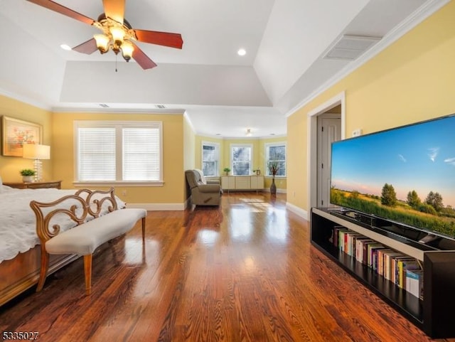 bedroom with a raised ceiling, wood-type flooring, vaulted ceiling, and ornamental molding