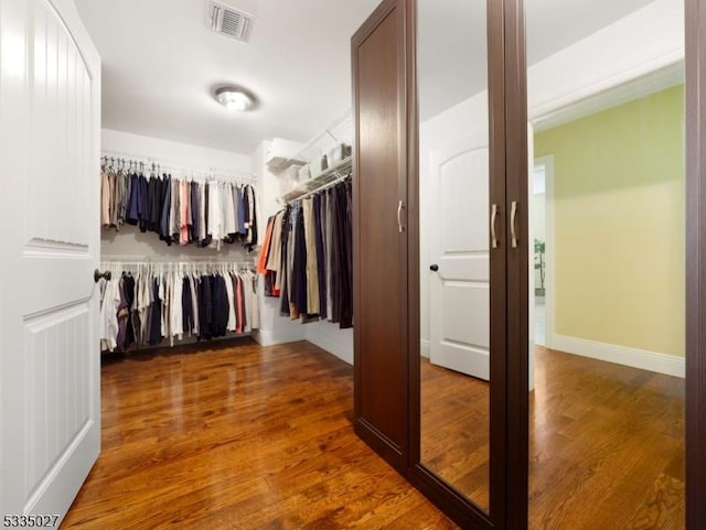 spacious closet with dark hardwood / wood-style floors