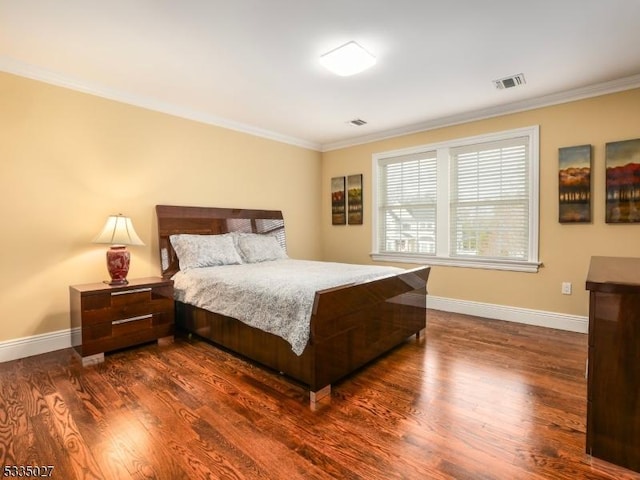 bedroom featuring crown molding and dark hardwood / wood-style floors