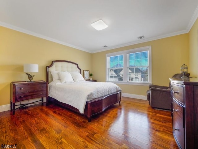 bedroom featuring crown molding and dark hardwood / wood-style floors