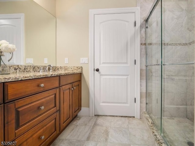 bathroom featuring vanity and a shower with door