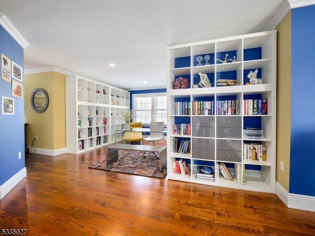 rec room featuring hardwood / wood-style flooring, ornamental molding, and built in features