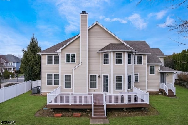 back of property featuring a wooden deck, a lawn, and central air condition unit